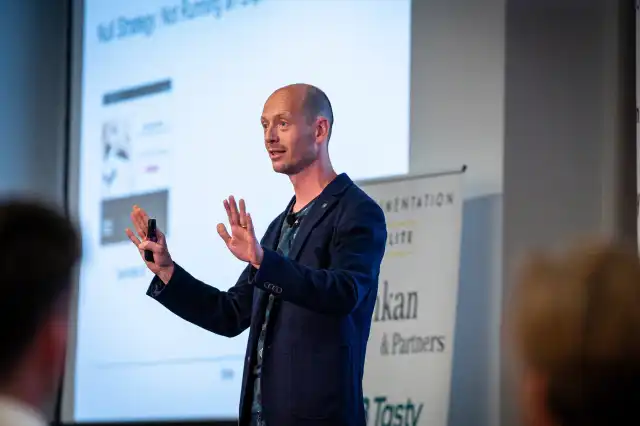 Lukas on stage presenting at Exp Elite in Birmingham, 2023.