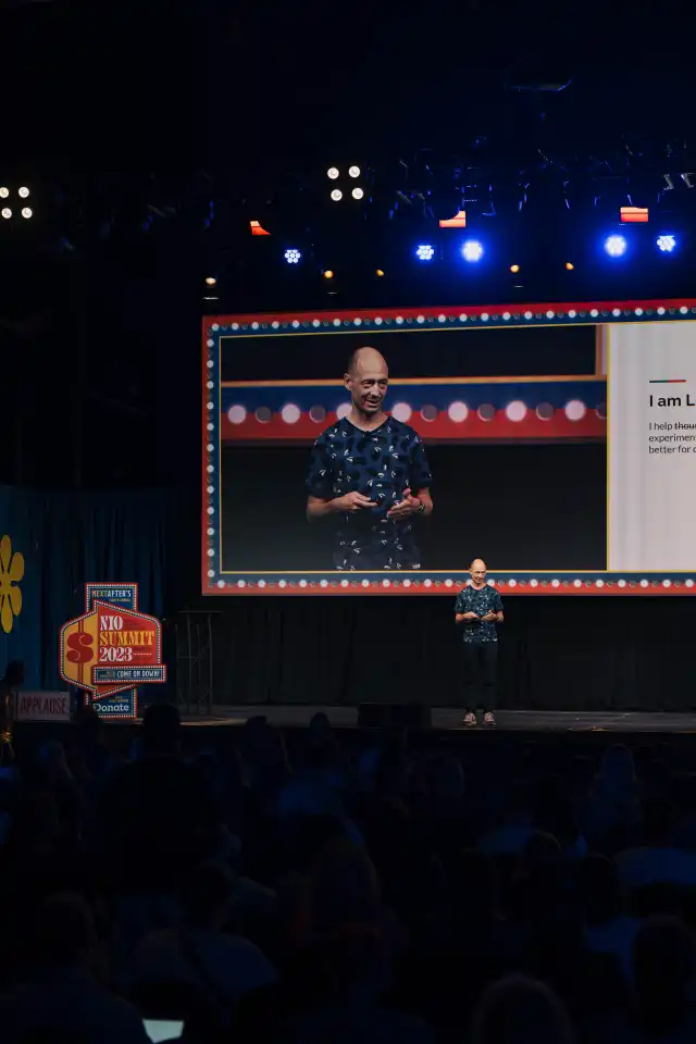 Lukas on stage presenting at NIO Summit in Dallas, 2023.